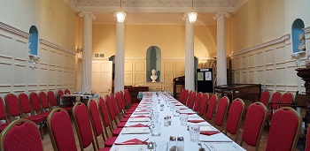 A banquet hall with furniture decorated for an event