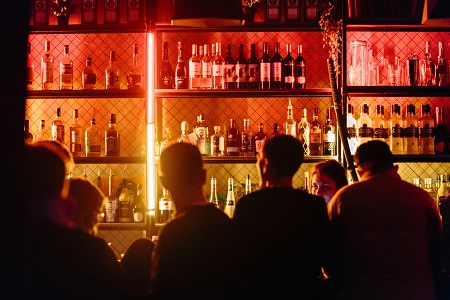 A crowded bar in a busy pub
